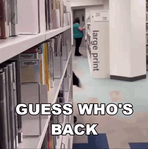 A Library With A Large Print Sign In The Corner GIF