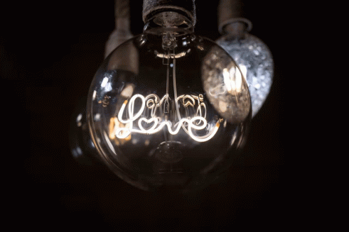 A Light Bulb That Has The Word Love Written On It GIF