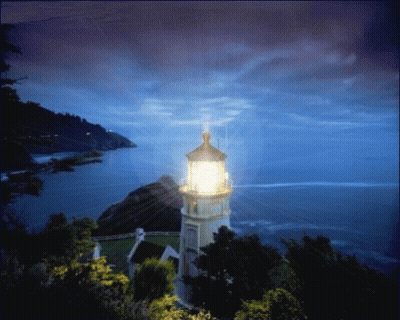 A Lighthouse On A Hill Overlooking A Body Of Water At Night GIF
