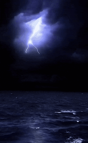 A Lightning Bolt Is Visible Over The Ocean GIF