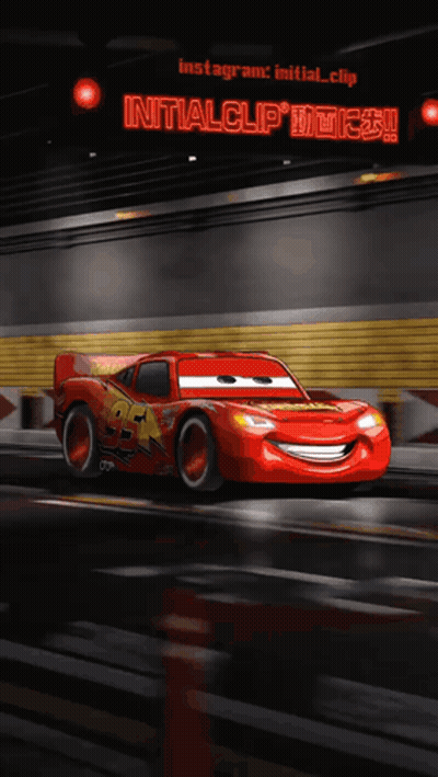A Lightning Mcqueen From The Movie Cars Is Driving Down The Road GIF