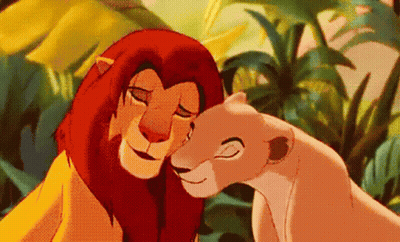 A Lion And A Lioness From The Lion King Are Hugging Each Other In The Jungle . GIF