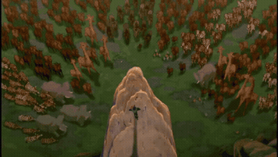 A Lion Is Sitting On Top Of A Rocky Cliff GIF