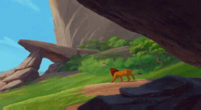 A Lion Is Walking Down A Dirt Path In The Jungle GIF