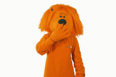 A Lion Mascot Covering His Mouth With His Hand While Wearing An Orange Sweater That Says Nb GIF