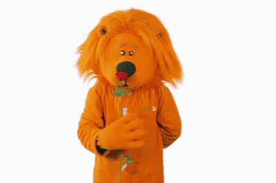 A Lion Mascot Is Holding A Rose In His Hand GIF