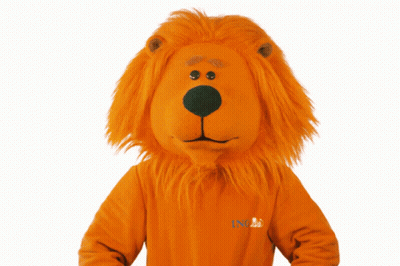 A Lion Mascot Is Wearing A Sweater That Says Ing On It GIF