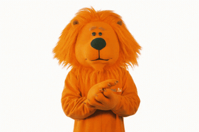 A Lion Mascot Is Wearing An Orange Sweater With The Word Abc On The Sleeve GIF