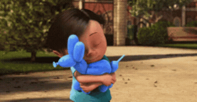 A Little Boy Holding A Blue Balloon Dog GIF