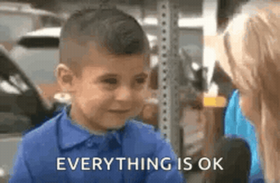 A Little Boy In A Blue Shirt Is Crying While Talking To A Woman And Says `` Everything Is Ok '' . GIF