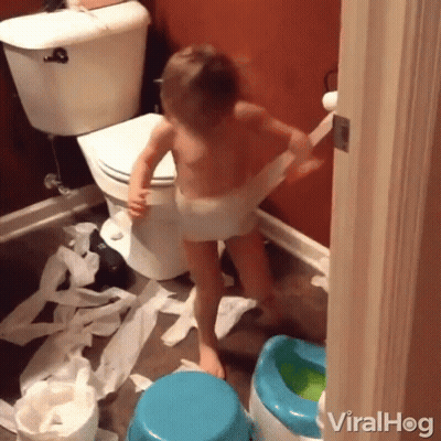 A Little Boy In A Diaper Is Playing With Toilet Paper GIF