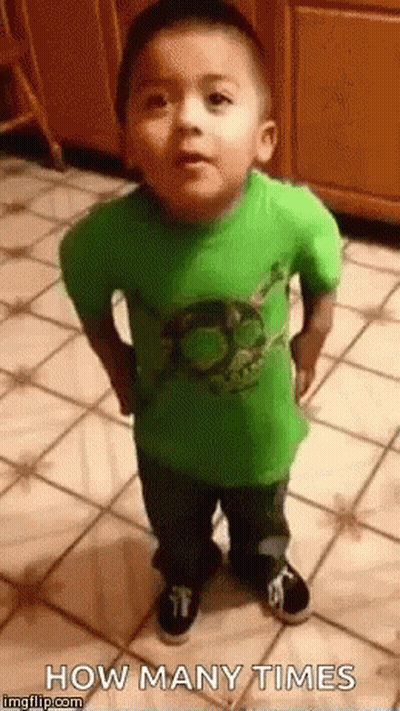 A Little Boy In A Green Shirt Is Standing On A Tiled Floor And Looking At The Camera . GIF