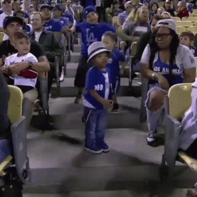 A Little Boy In A La Dodgers Shirt Is Dancing In The Stands GIF