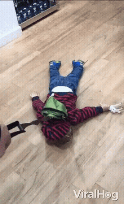 A Little Boy Is Laying On The Floor With The Word Viralhog Written On The Bottom GIF