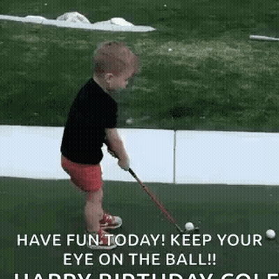 A Little Boy Is Playing Golf With A Golf Club On A Green . GIF