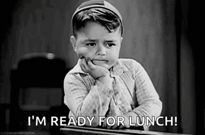 A Little Boy Is Sitting At A Desk With His Hand On His Chin And Saying `` I 'M Ready For Lunch ! '' GIF