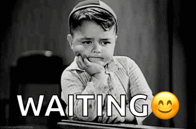 A Little Boy Is Sitting At A Desk With The Word Waiting Written On It GIF