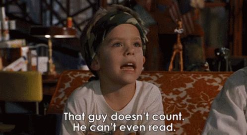 A Little Boy Is Sitting On A Couch With The Words That Guy Does N't Count He Can 'T Even Read GIF