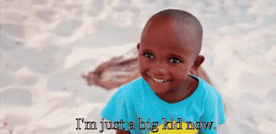 A Little Boy Is Smiling With The Words I 'M Just A Big Kid Now GIF