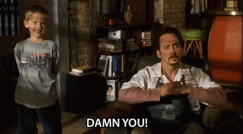 A Little Boy Standing Next To A Man Who Is Sitting In A Chair With The Words Damn You On The Screen GIF