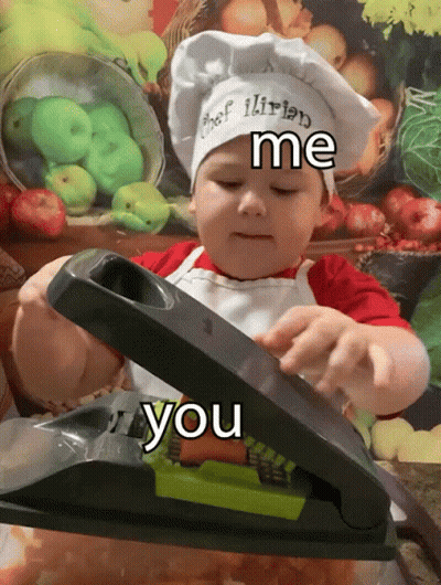 A Little Boy Wearing A Chef 'S Hat And Apron Is Using A Slicer GIF