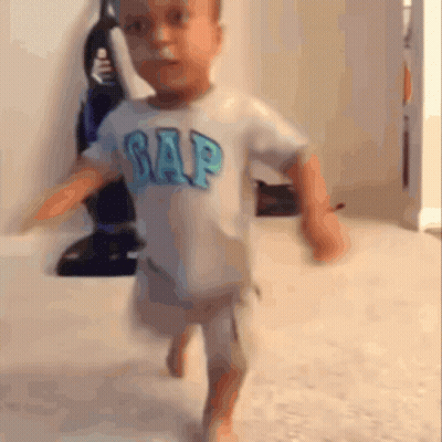 A Little Boy Wearing A Gap Shirt Is Running GIF
