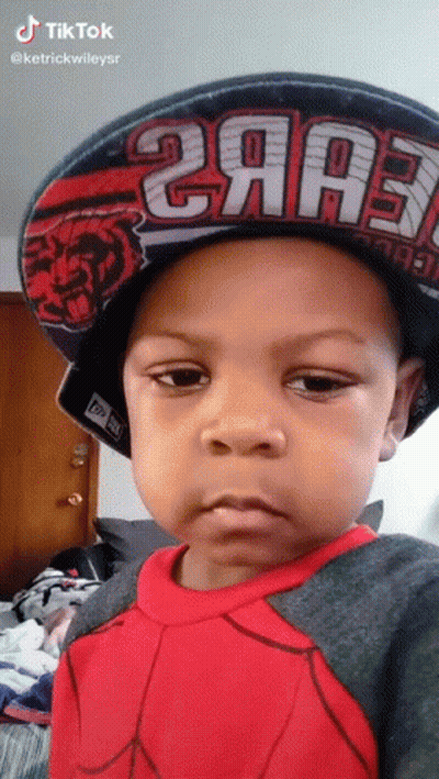 A Little Boy Wearing A Hat That Says 2Aa3 On It GIF