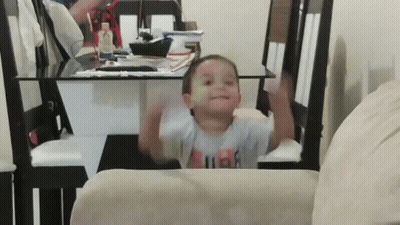 A Little Boy Wearing A Shirt That Says High Is Sitting On A Chair GIF