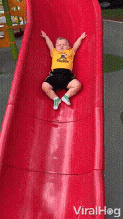 A Little Boy Wearing A Steelers Shirt Is Sitting On A Slide GIF