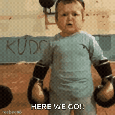 A Little Boy Wearing Boxing Gloves Says Here We Go GIF