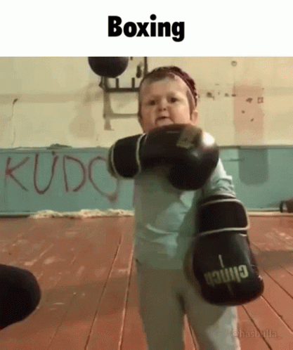 A Little Boy Wearing Boxing Gloves With The Word Boxing On The Bottom GIF