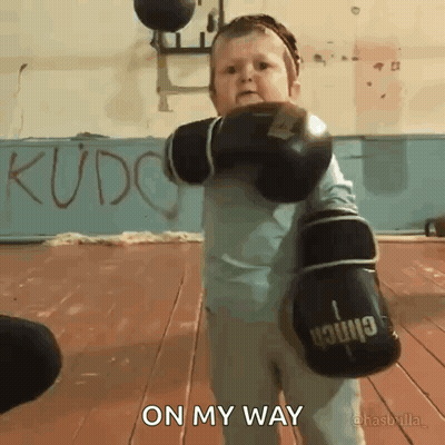 A Little Boy Wearing Boxing Gloves With The Words On My Way Above Him GIF