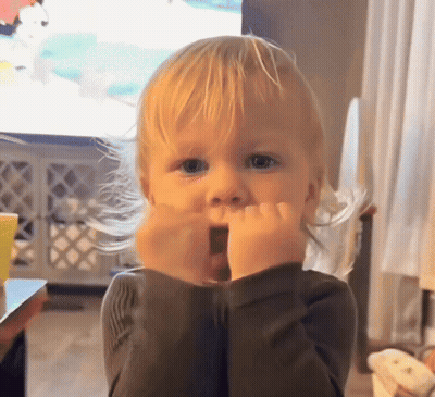 A Little Boy With Blonde Hair Is Making A Surprised Face GIF