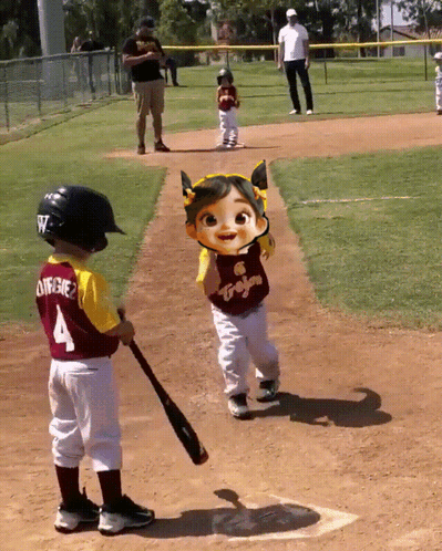 A Little Boy With The Number 4 On His Jersey Is Holding A Bat GIF