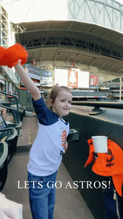 A Little Girl In A Baseball Stadium With The Words Lets Go Astros GIF