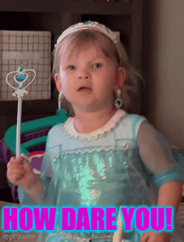 A Little Girl In A Blue Dress Is Holding A Wand With The Words How Dare You Written On It GIF