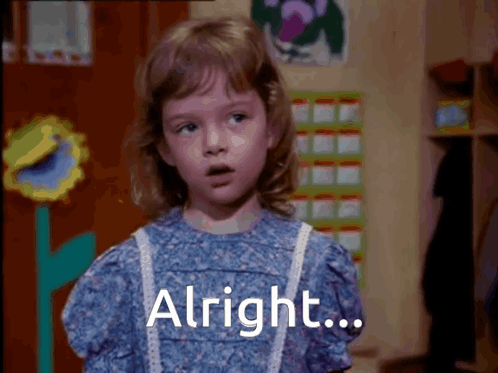 A Little Girl In A Blue Dress Says Alright On The Screen GIF