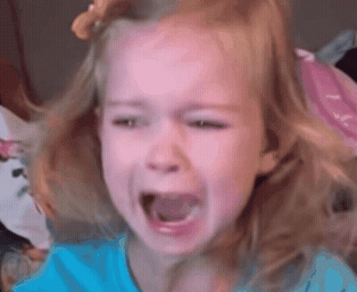 A Little Girl In A Blue Shirt Is Crying GIF