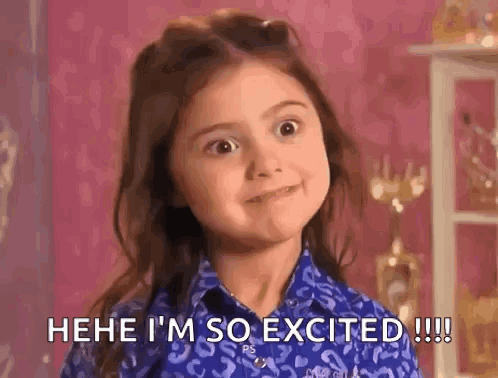 A Little Girl In A Blue Shirt Is Making A Funny Face And Saying `` I 'M So Excited '' . GIF