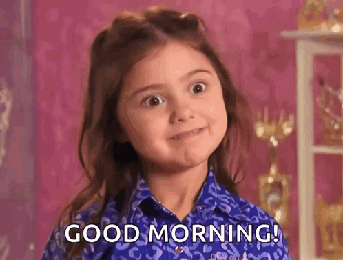 A Little Girl In A Blue Shirt Is Saying Good Morning GIF
