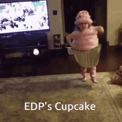 A Little Girl In A Cupcake Costume Jumping In The Air GIF