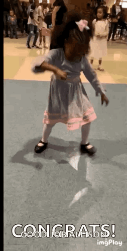 A Little Girl In A Dress Is Dancing In A Room With The Words Congrats On The Bottom . GIF