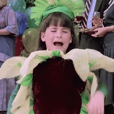 A Little Girl In A Flower Costume Is Crying GIF