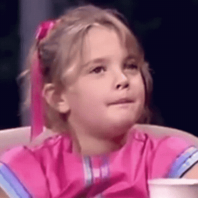 A Little Girl In A Pink Dress Is Sitting In A Chair With A Cup Of Coffee . GIF