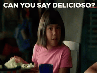 A Little Girl In A Pink Shirt Is Sitting At A Table Eating A Salad . GIF