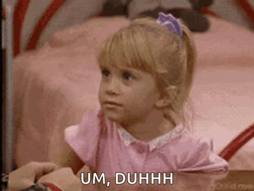 A Little Girl In A Pink Shirt Is Sitting On A Bed And Saying Um , Duhhh . GIF