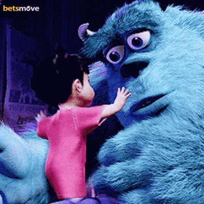A Little Girl In A Pink Shirt Is Standing Next To A Monster From The Movie Monsters Inc. GIF