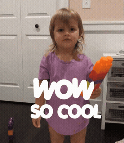 A Little Girl In A Purple Shirt Is Holding A Water Gun And Says Wow So Cool GIF