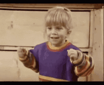 A Little Girl In A Purple Shirt Is Pointing GIF