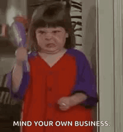 A Little Girl In A Red And Purple Dress Is Holding A Hair Dryer In Her Hand . GIF
